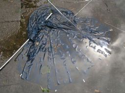 the sky reflected in a broken umbrella